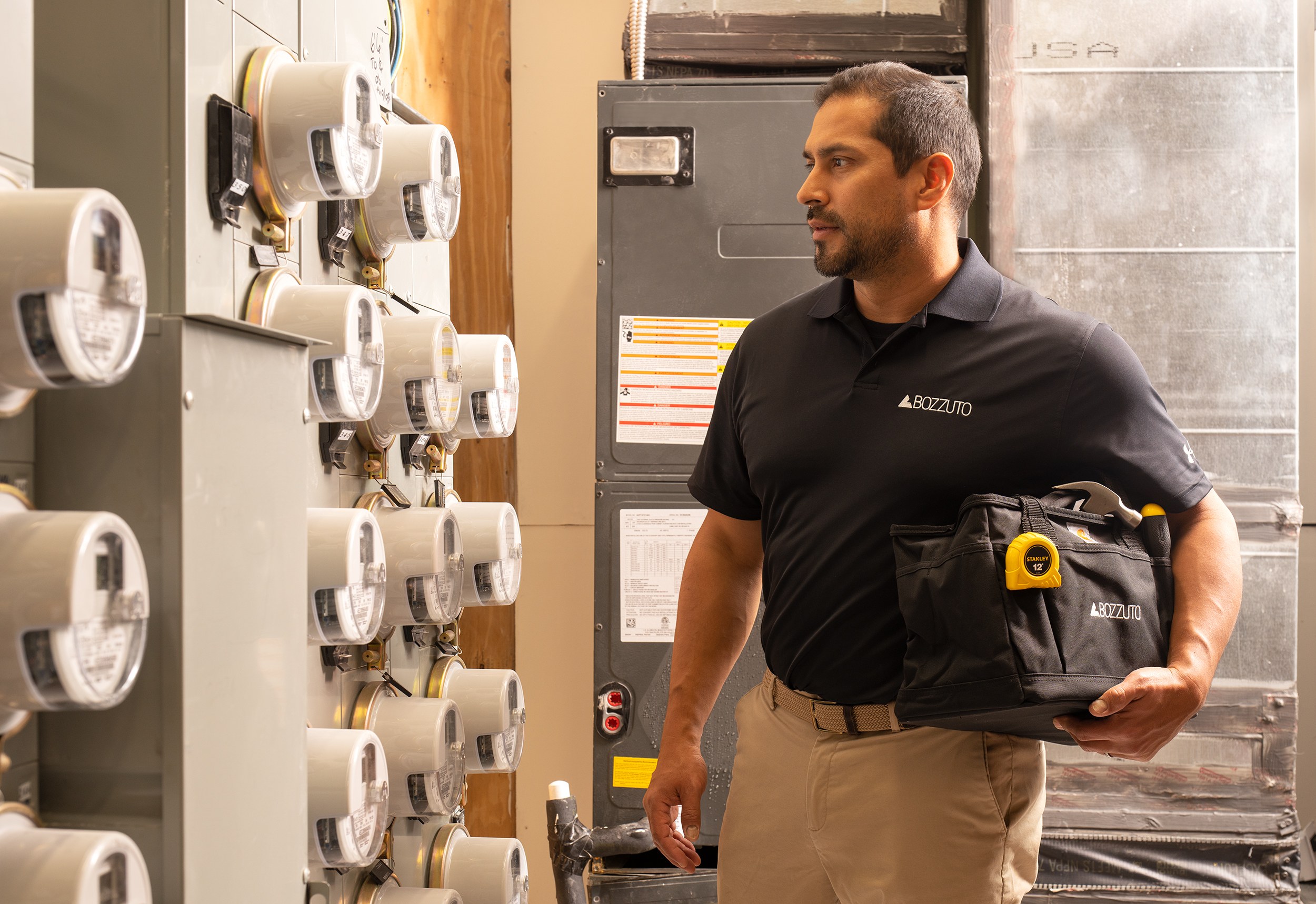 A maintenance guy looking at electric meters