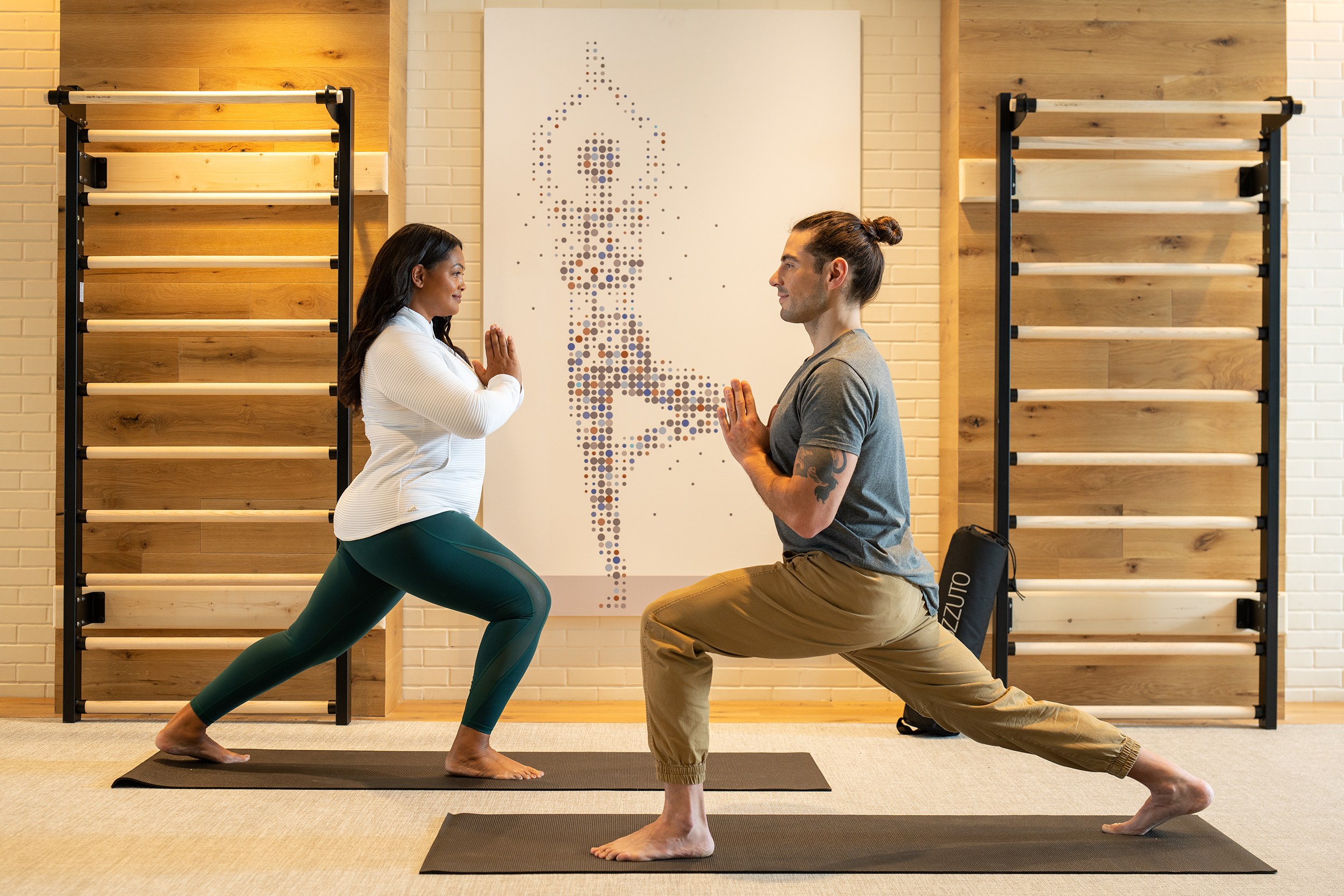 A man and woman doing yoga exercises
